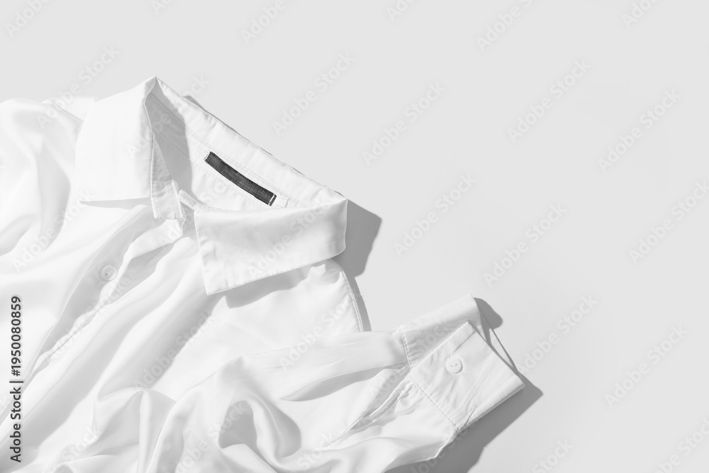 Fototapeta premium Button shirt on white background, top view
