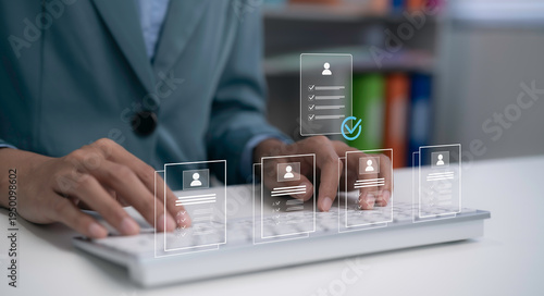 Cuadro en lienzo Businesswoman typing on keyboard with digital HR interface showing candidate profiles and checklist verification