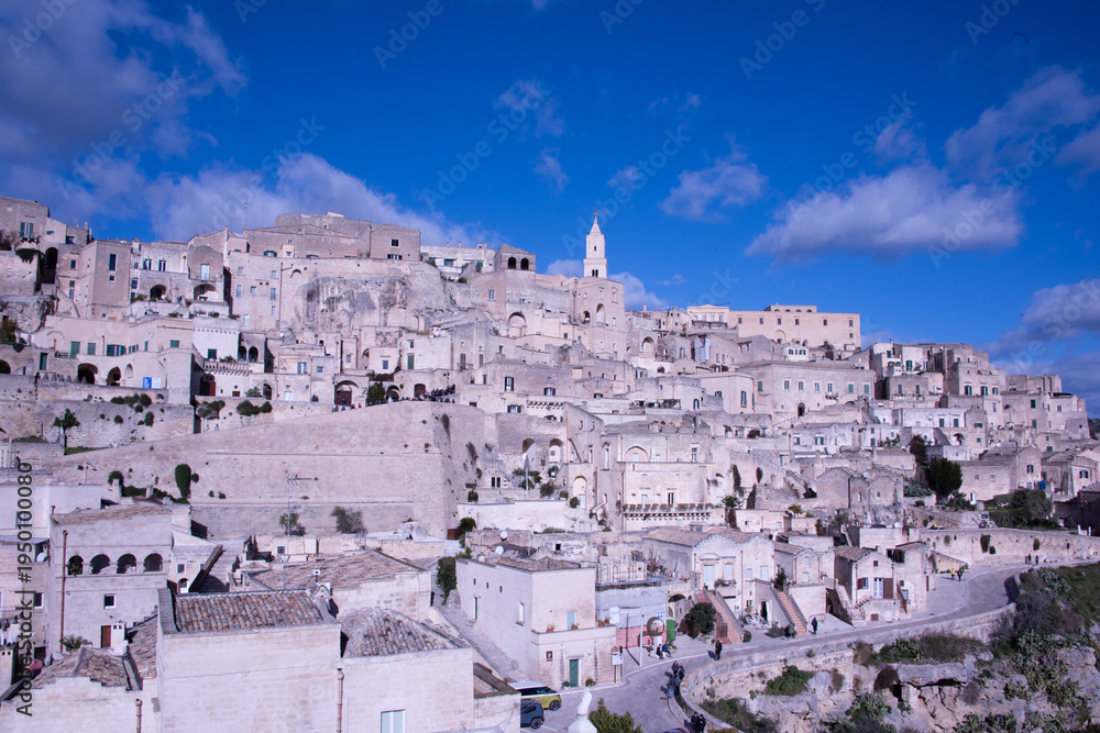 Fototapeta premium Carved into stone and shaped by centuries, Matera rises from the rocks of southern Italy like a timeless masterpiece.