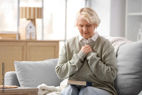 Religious senior woman with...