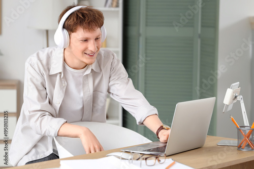 Young man in headphones wor...