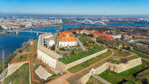 Aerial view of the fortress standing majestically above the Danube, its terracotta roofs contrasting against the clear blue sky, Petrovaradin, Vojvodina, Serbia.