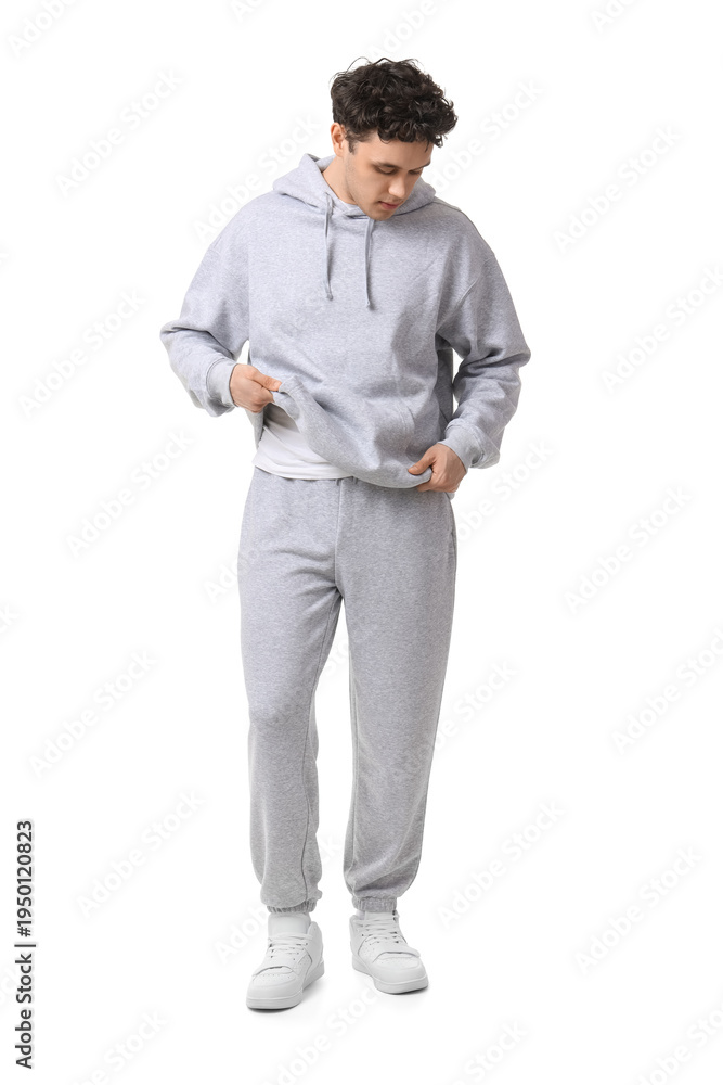 Fototapeta premium Young man in grey sports suit on white background