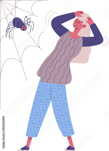 Woman reacting with fear to spider and spiderweb