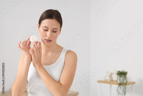 Young woman with acne probl...