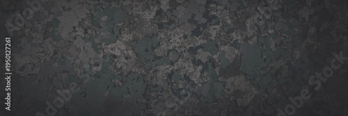 Dark wide panoramic background. Peeling paint on a concrete wall. Faded dark texture of old cracked flaking paint. Weathered rough painted surface with patterns of cracks. Shaded background for design