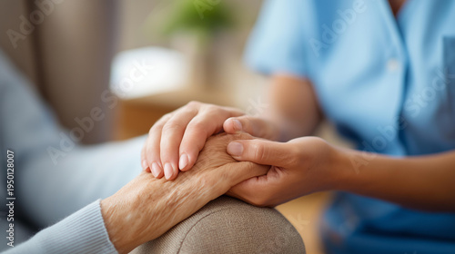 Close-up of a faceless nurse's hands gently holding a senior patient's hands on a care home armchair, warm natural light, defocused clinical interior behind, nurse empathy, elderly patient care,