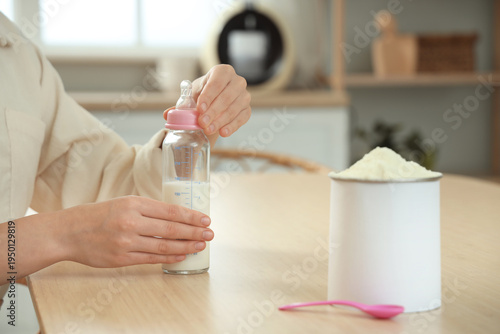 Woman with jar of powdered ...
