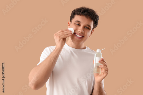 Young man with bottle of mi...