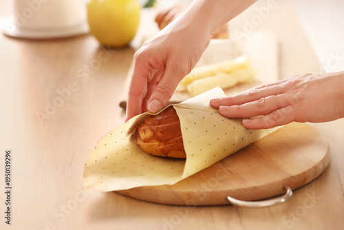 Young woman wrapping sweet ...