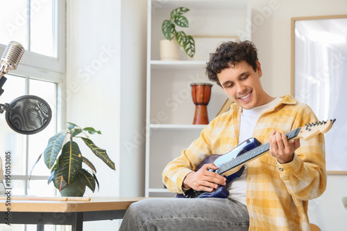 Young happy man playing new...