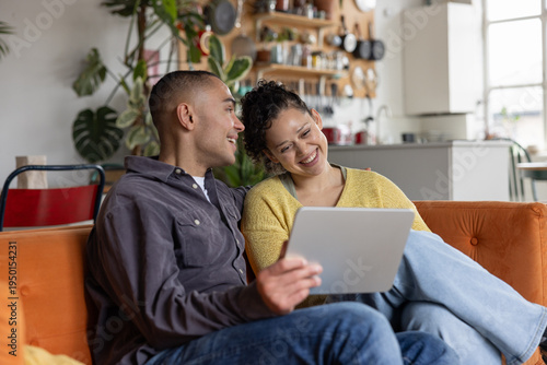 Young couple streaming entertainment on their digital tablet