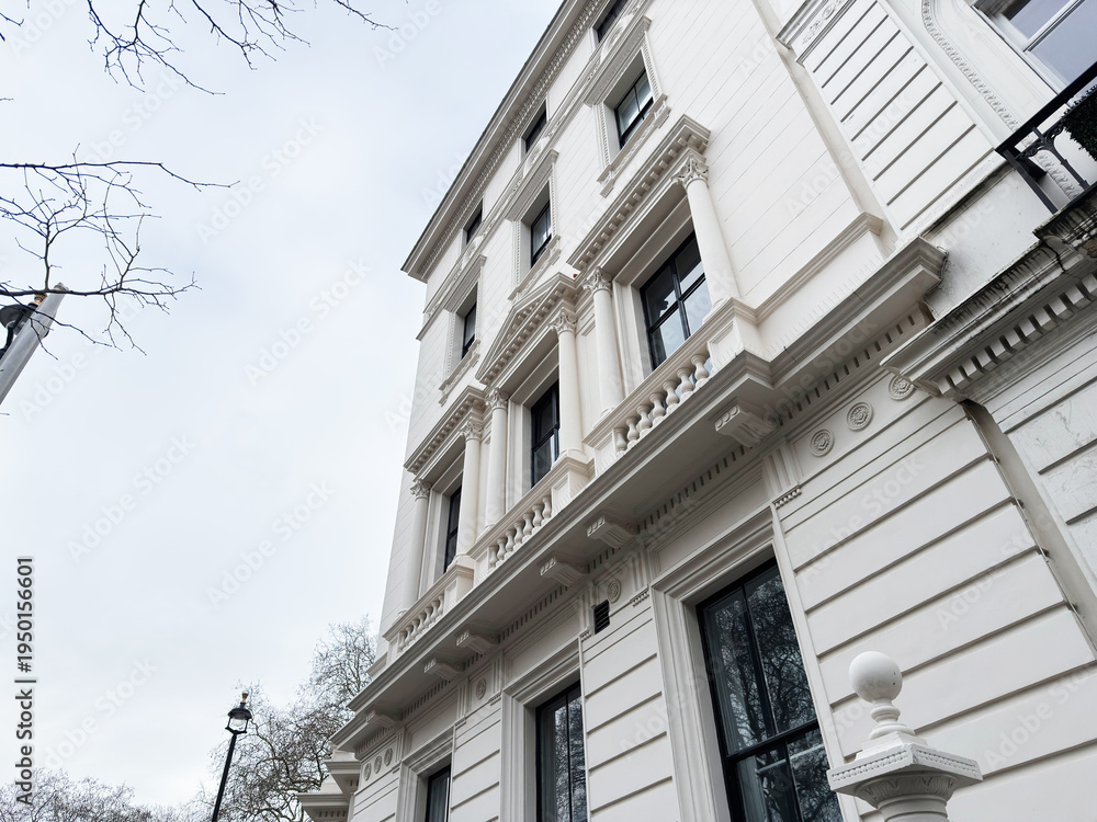 Fototapeta premium Elegant white building with neoclassical columns and ornate windows in London UK facade details shown