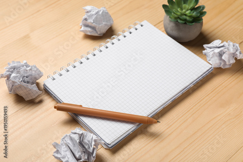 Notebook and crumpled piece...