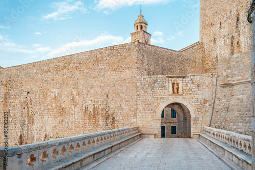 Stone bridge leading to Pile Gate main entrance to Dubrovnik old town with limestone defensive walls surround medieval city on the Adriatic coast, Dalmatia, Croatia