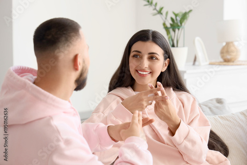 Couple using sign language ...