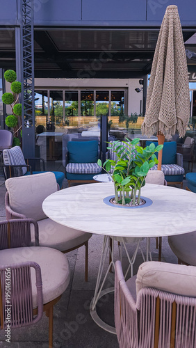 Stylish Outdoor Lounge Area With Round Table and Cushioned Chairs