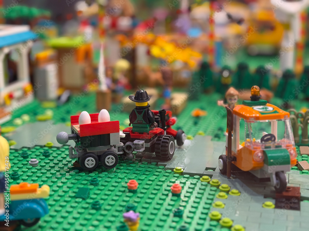 Fototapeta premium Lego tractor with egg trailer on green baseplate