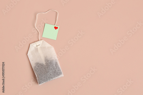 Tea bag with green label an...