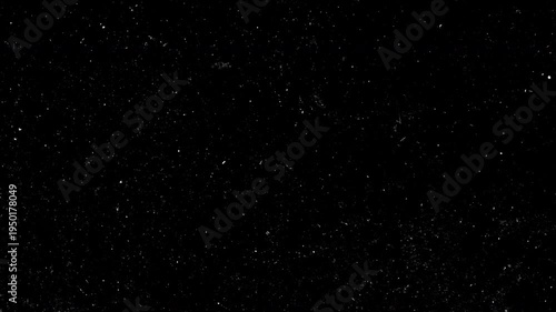 Animation cinematic film dust and heavy grain texture overlay on black background. Vintage style grunge motion effect features realistic white particles, scratches and fibers, perfect for adding an an