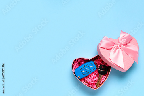 Gift box with car key on bl...