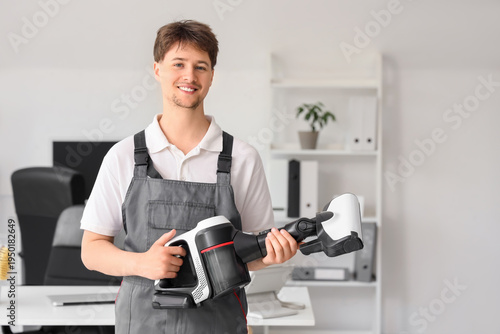 Young male janitor with mod...