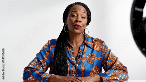 Smiling Woman With Braids Talking to Camera in Front of Ring Light