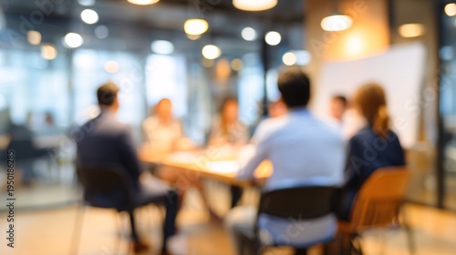 Blurry business meeting with team discussing ideas in modern office