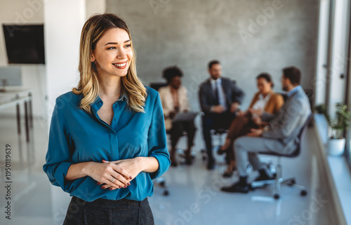 Young happy successful business woman working in corporate office