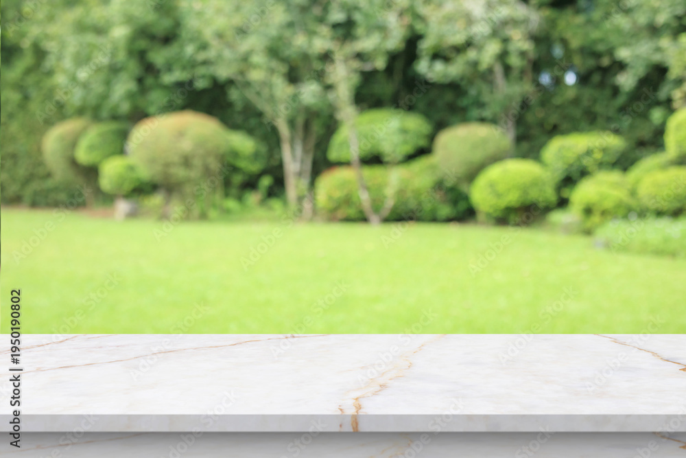 Fototapeta premium Empty marble table top with abstract blur green park garden background