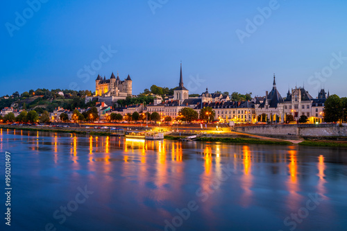 Long exposure of Saumur, Pays de la Loire, Northwestern France on summer evening at dusk. The Loire River flows through Saumur.