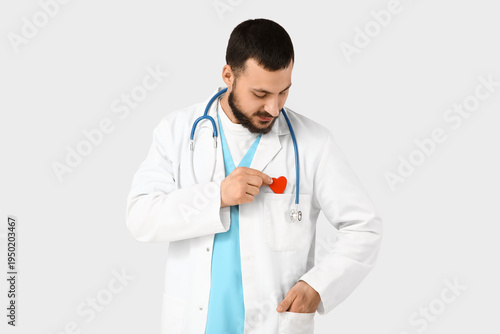 Young happy male doctor wit...