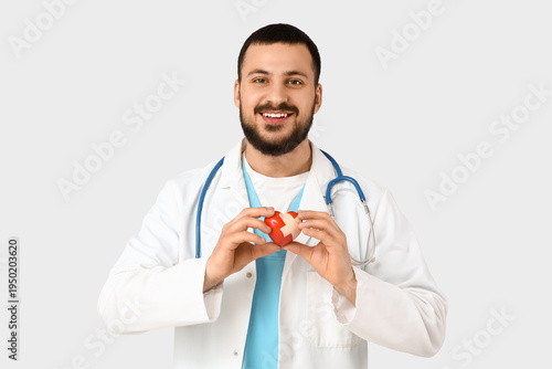 Young happy male doctor hol...