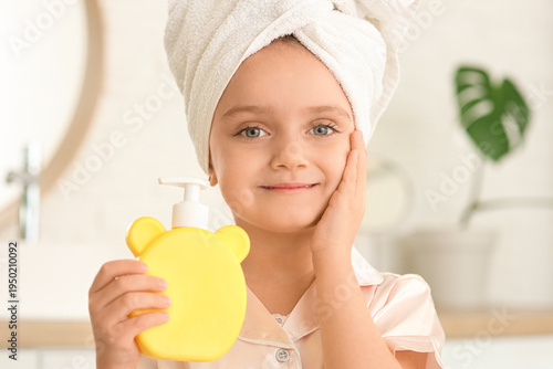 Little girl with soap bottl...