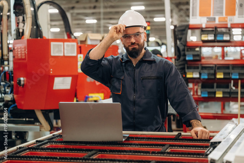 Wallpaper Mural Silver colored laptop, using it. Warehouse worker in an industrial environment of a factory or storage area Torontodigital.ca