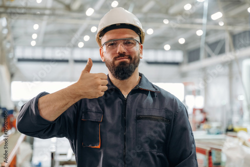 Wallpaper Mural Everything is under control, showing hand gesture. Warehouse worker in an industrial environment of a factory or storage area Torontodigital.ca