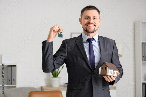 Real estate agent with key ...