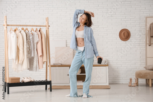 Young woman holding cup of ...