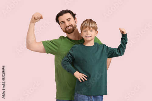 Happy dad and son showing m...