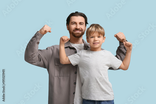 Happy dad and son showing m...