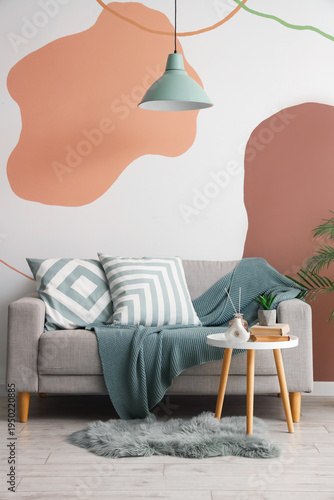 Cozy sofa, houseplant and c...