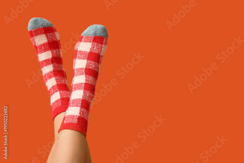 Legs of young woman in warm...