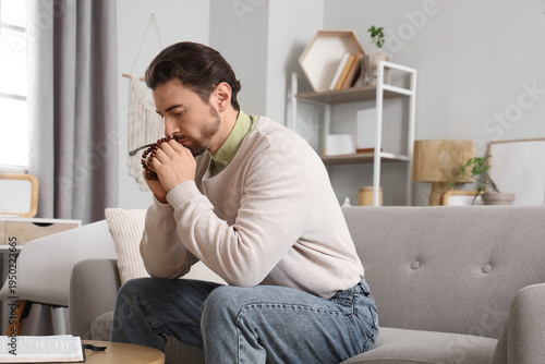Religious man praying at  home