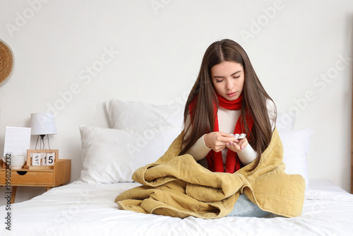 Ill young woman with pills ...