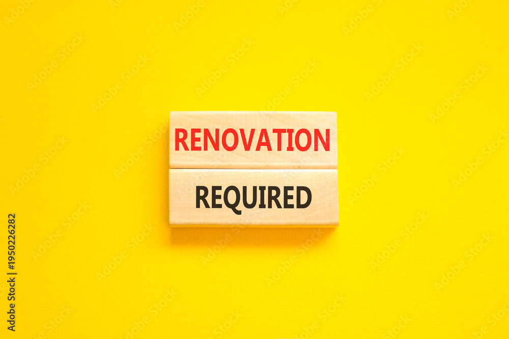Naklejka premium Renovation required words symbol. Concept words Renovation required on beautiful wooden blocks. Beautiful yellow background. Business and Renovation required words concept. Copy space.