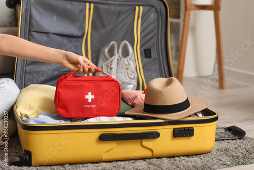 Young woman with suitcase a...