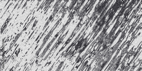 Abstract grayscale texture with diagonal streaks and speckled noise creating a dynamic and energetic background for graphic design and artistic overlays