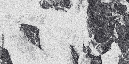 Abstract monochrome textured background with rough organic shapes and a speckled grainy effect creating a naturalistic and weathered surface appearance