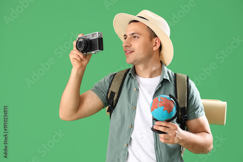 Male tourist with globe and...