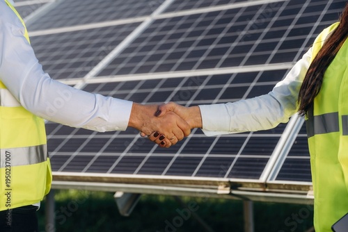 Wallpaper Mural Handshake, cooperation, success. Two solar engineers standing together at a photovoltaic field, in bright safety vests Torontodigital.ca